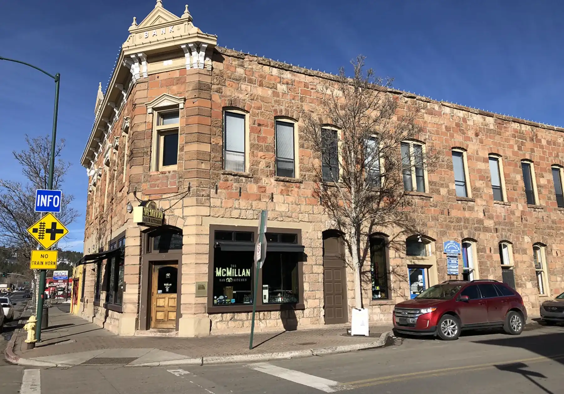 Corner sandstone bank building housing McMillan Bar and Kitchen in downtown Flagstaff