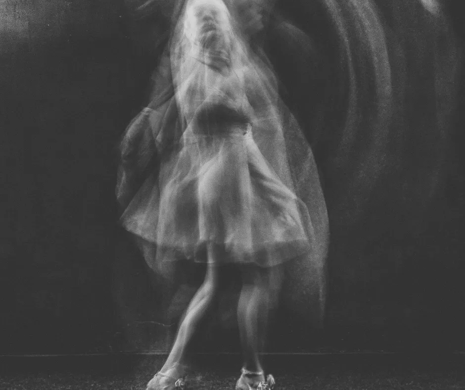 Blurred long-exposure black and white figure in a dress like a ghostly apparition