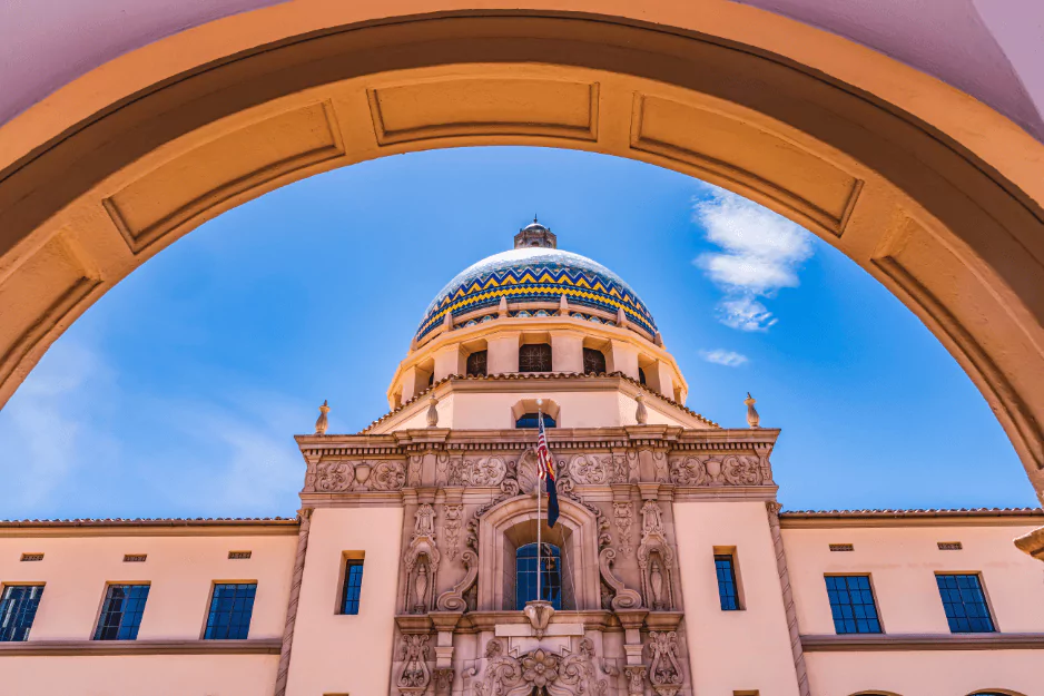 Ornate tiled dome of a Spanish colonial courthouse framed by a stone arch