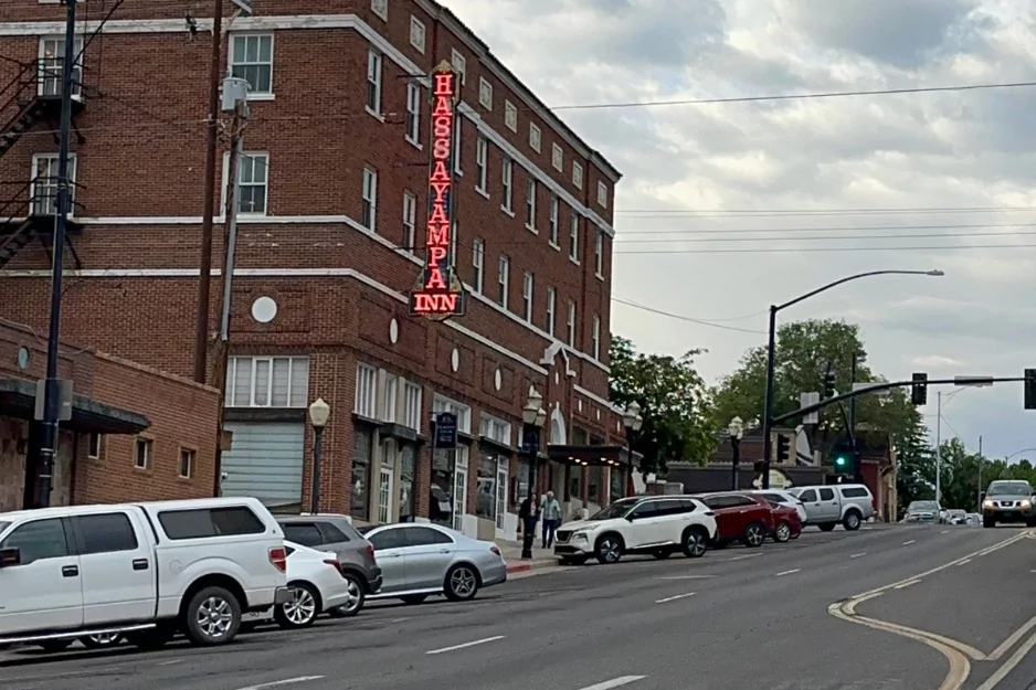 The Hassayampa Inn brick building with red neon vertical sign on a Prescott street