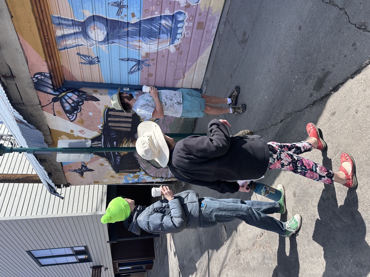 Coffee in hand, guests take in a butterfly-filled mural, giant bare foot included, tucked into a downtown alley.