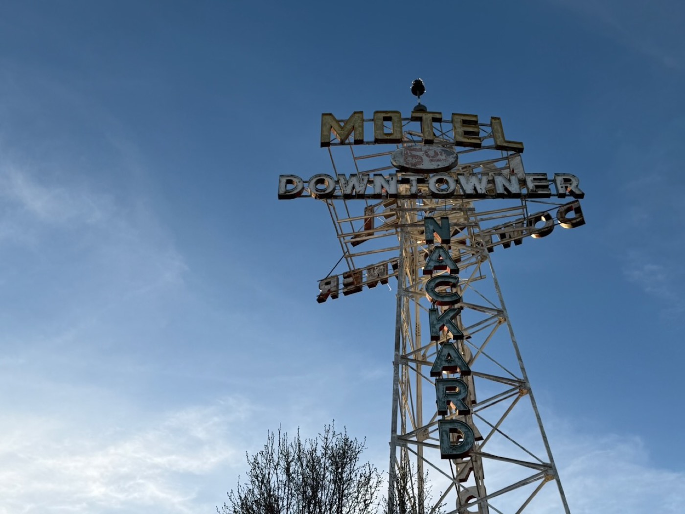 The Motel Downtowner neon letters lit at dusk in Flagstaff
