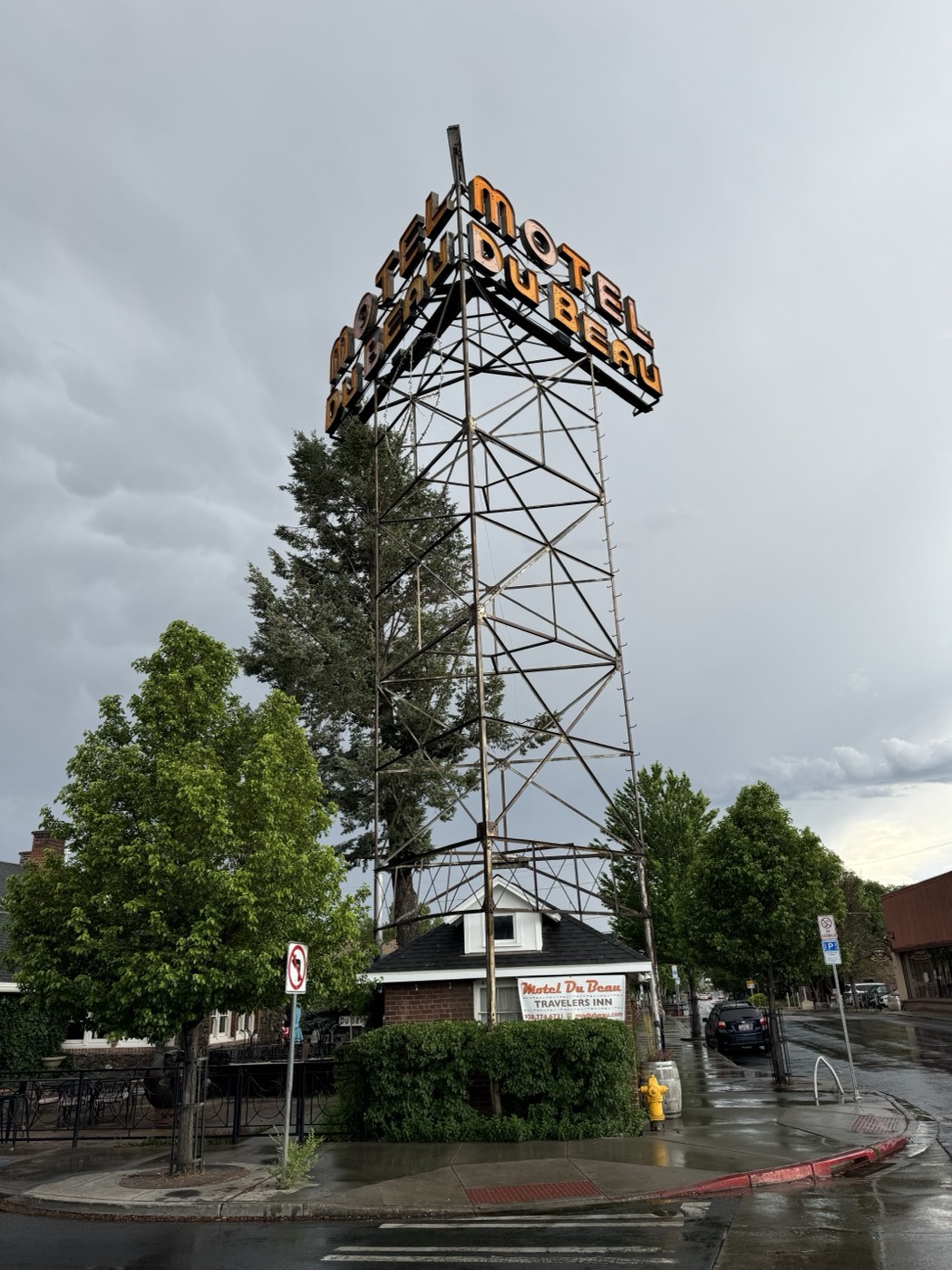 Rain-washed streets frame the Motel Du Beau sign, a steel landmark from the dawn of America's motor hotels.