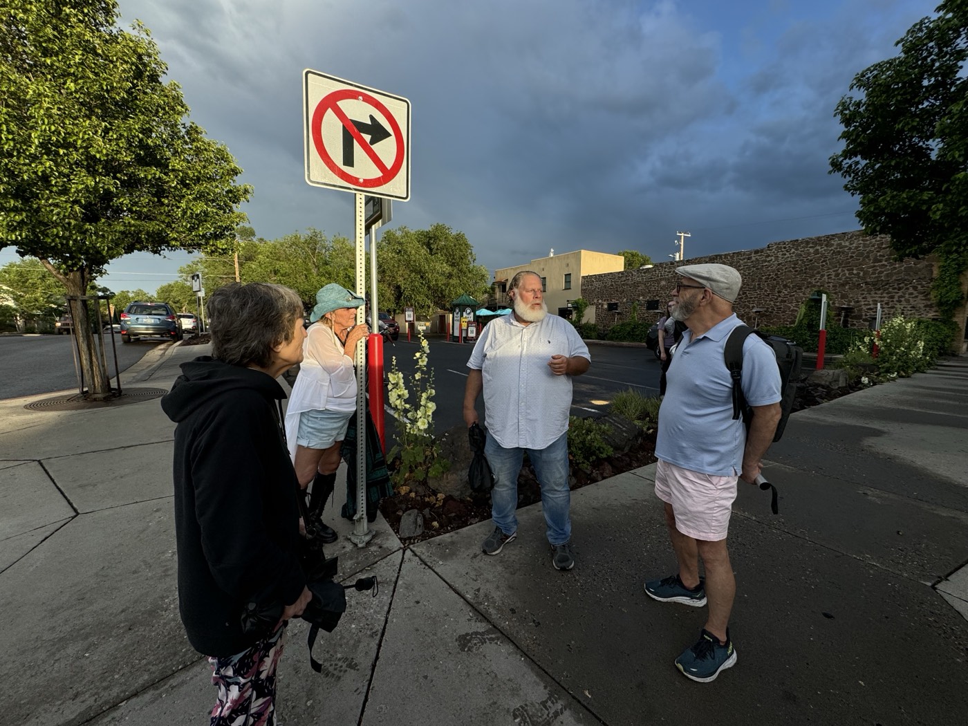 Golden storm light catches the group mid-conversation at a Southside corner along old Route 66.