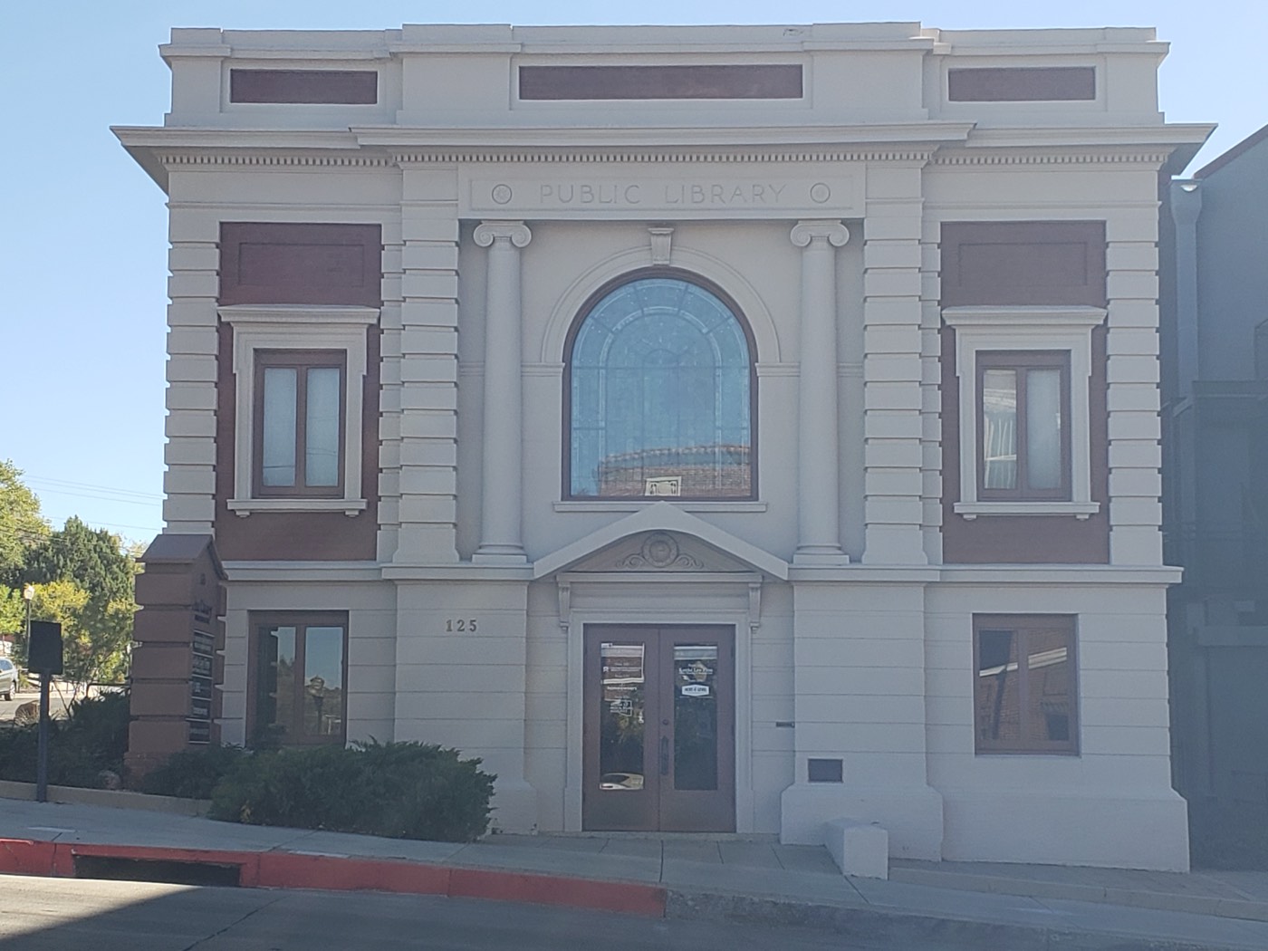 Carved letters still crown the century-old Public Library building, a proud leftover of territorial-era civic ambition.