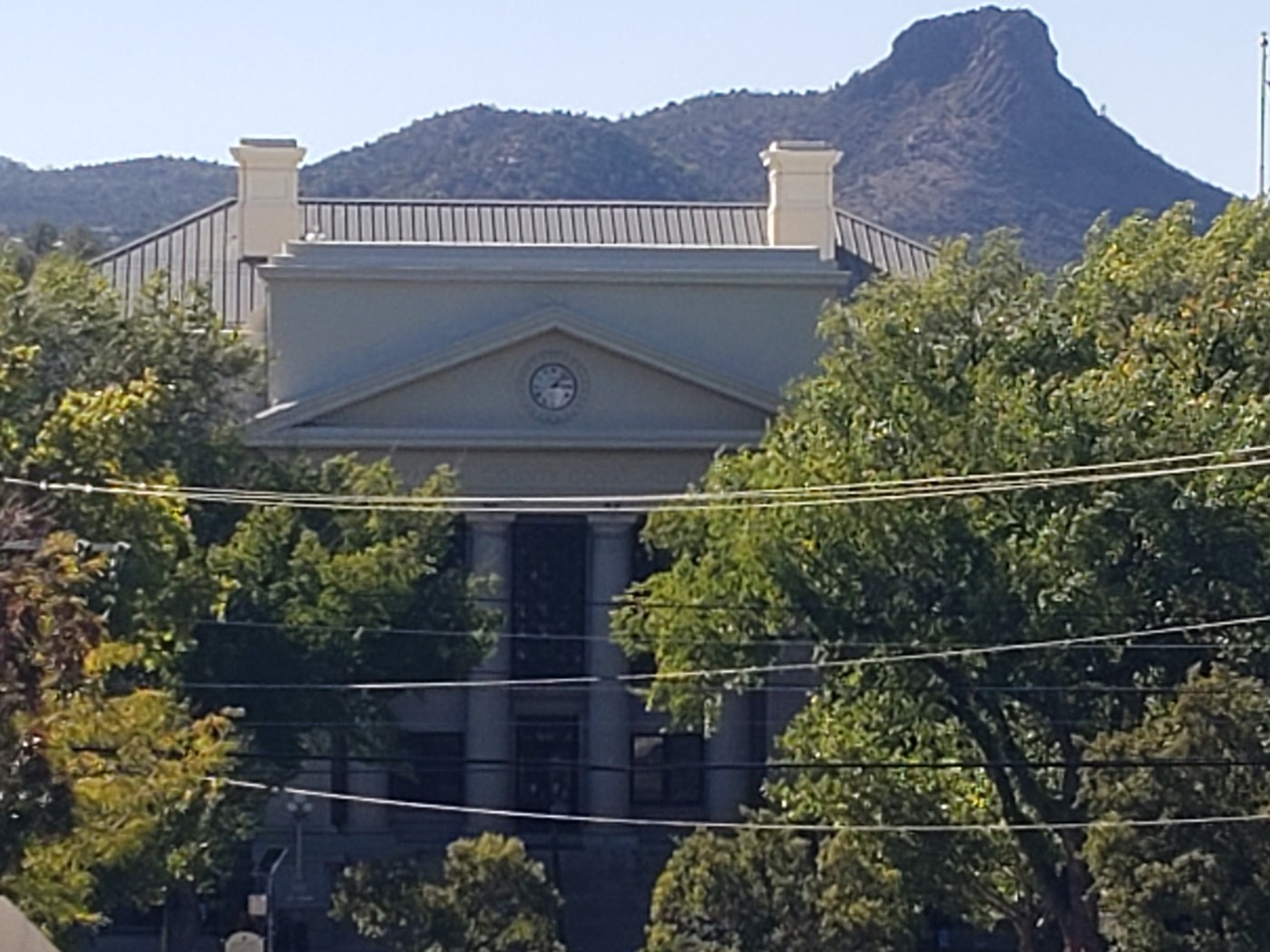 Between 1875 and 1925, eleven men were legally hanged on these courthouse grounds, a grim tally guides recount beneath the clock.