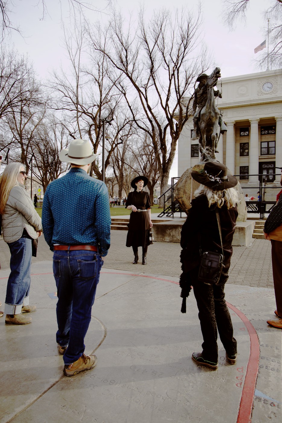 Walking tour guests visit the Roughrider statue at Prescott's Courthouse Plaza, one of Arizona's most significant monuments to its Wild West heritage and connection to Teddy Roosevelt.