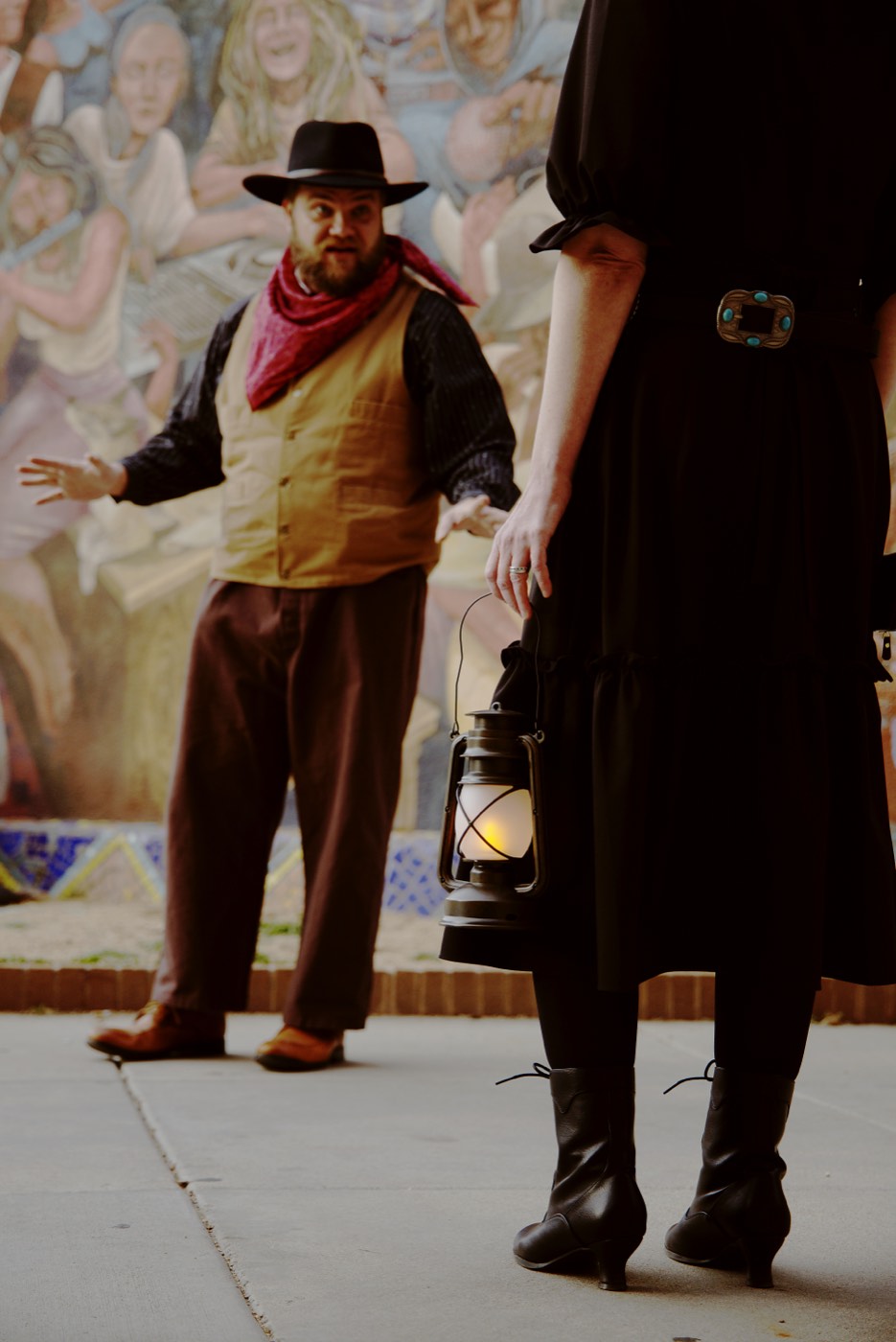 A Freaky Foot Tours guide carries a lantern through downtown Prescott on the haunted history walking tour, illuminating the dark stories behind Whiskey Row's most infamous landmarks.