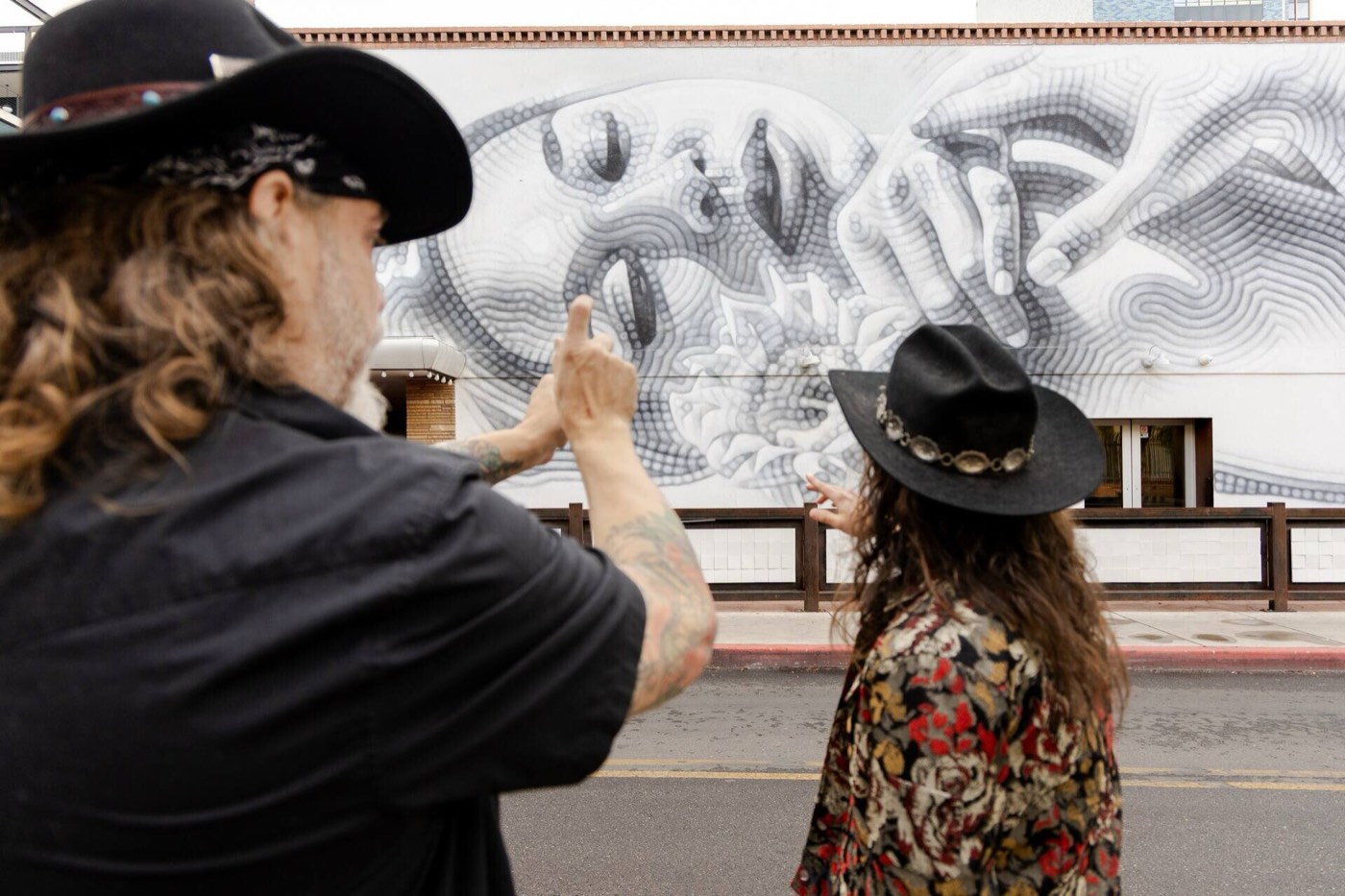 Guides at the black and white botanical mural on the Tucson mural tour