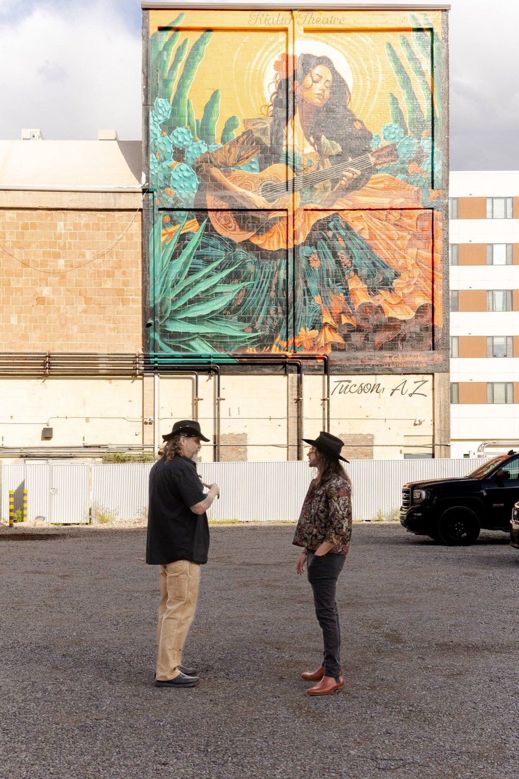 Two Freaky Foot Tours guides beneath Ignacio Garcia's Rialto Theatre mural