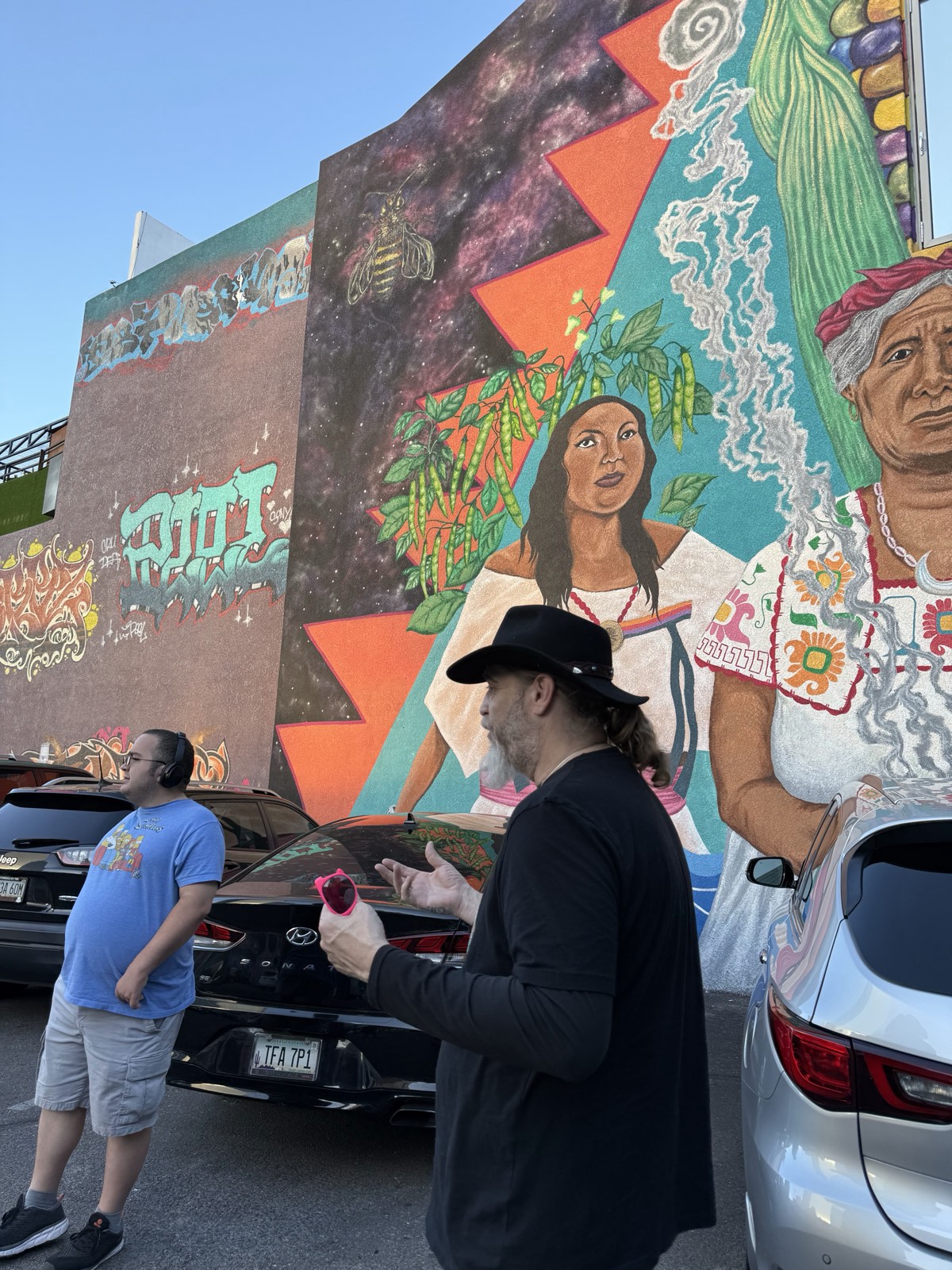 Guests viewing the Las Tres Hermanas mural on the Tucson mural tour